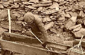 Miner working with a sluice