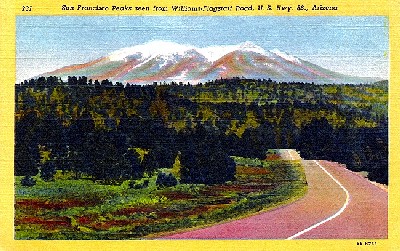 Route 66 near Flagstaff, Arizona with snow covered San Francisco Peaks in background.