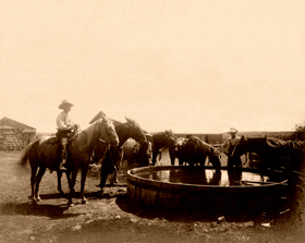 Cowboys at water tank in Dodge City, Kansas. 