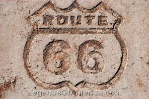 A Route 66 shield is carved in rock to commemorate where the Mother Road once ran through the Petrified Forest National Park in Arizona