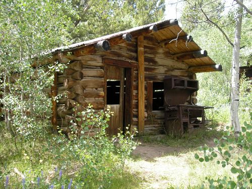 Rusting iron equipment, such as this oId stove, and a couple of iron box screens, can be seen around the cabins of Miners Delight, Wyoming.