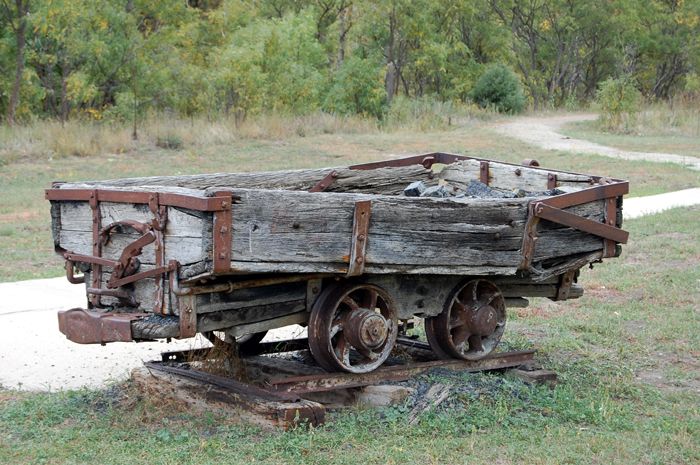 An old ore wagon sits near the entrance of Sugarite Canyon State Park near Raton, New Mexico. Photo by Kathy Weiser-Alexander.
