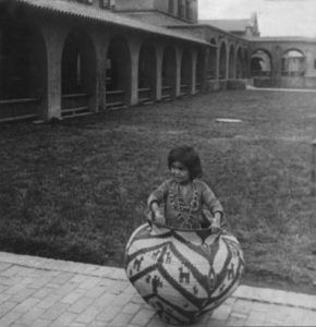 Indian girl in basket in Albuquerque, New Mexico, 1920.