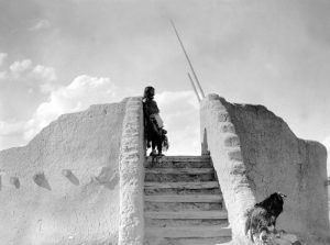 Tewa Indian guard at the top of the kiva stairs, San Ildefonso Pueblo, by Edward S. Curtis, 1905