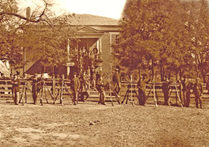Federal troops with rifles in front of the Appomattox, Virginia Court House. Timothy H. O'Sullivan, April, 1865.