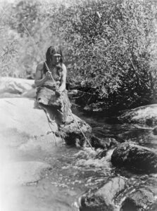 Southern Miwok man fishing with spear by Edward S. Curtis, 1924.