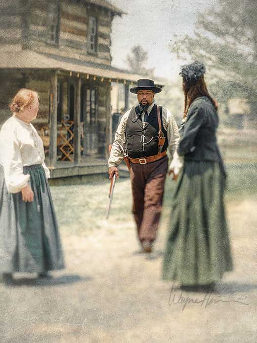 A richly colored Western photograph depicting a tense moment outside a frontier home. Photography by Wayne Heim.